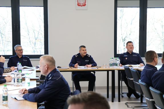 Na zdjęciu siedzą; pośrodku p.o. p.o. Komendant Miejski Policji w Rzeszowie mł. insp. Marek Pietrykowski, z jego prawej strony p.o. I Zastępca Komendanta Miejskiego Policji w Rzeszowie mł. insp. Rafał Dryś, z lewej strony Zastępca Komendanta Miejskiego podinsp. Maciej Gawryś.